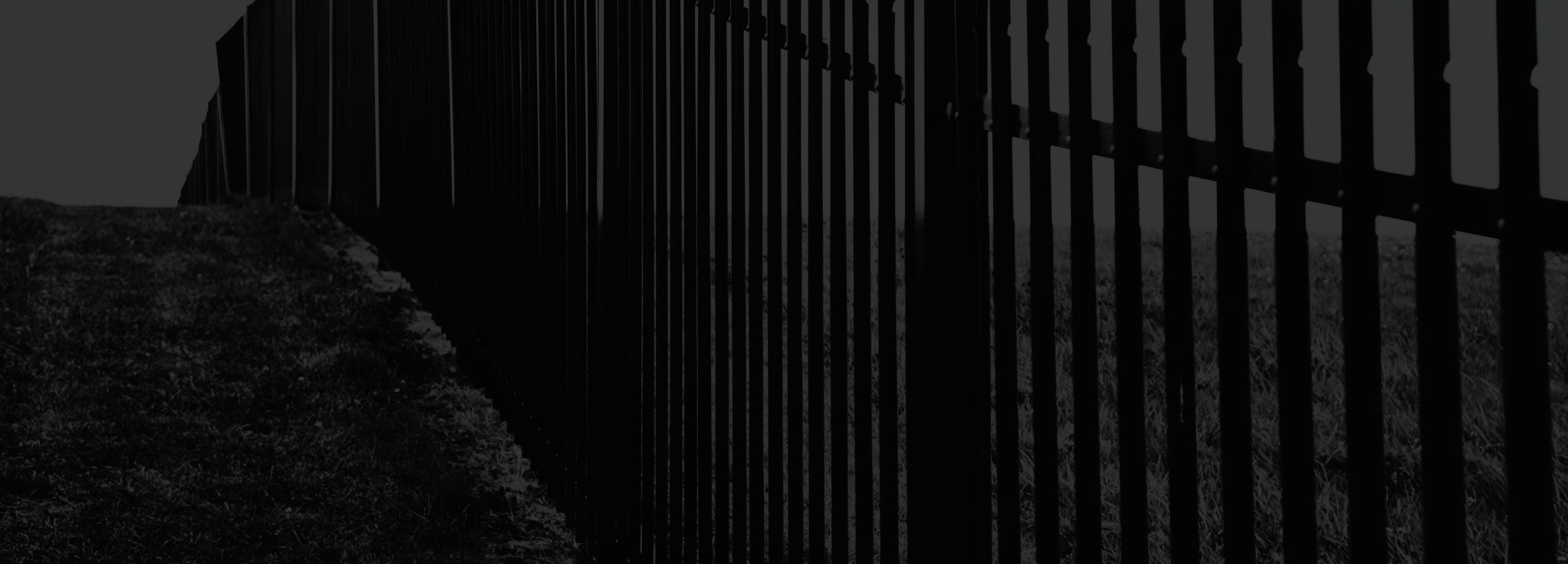 Dark fence with a blurred background