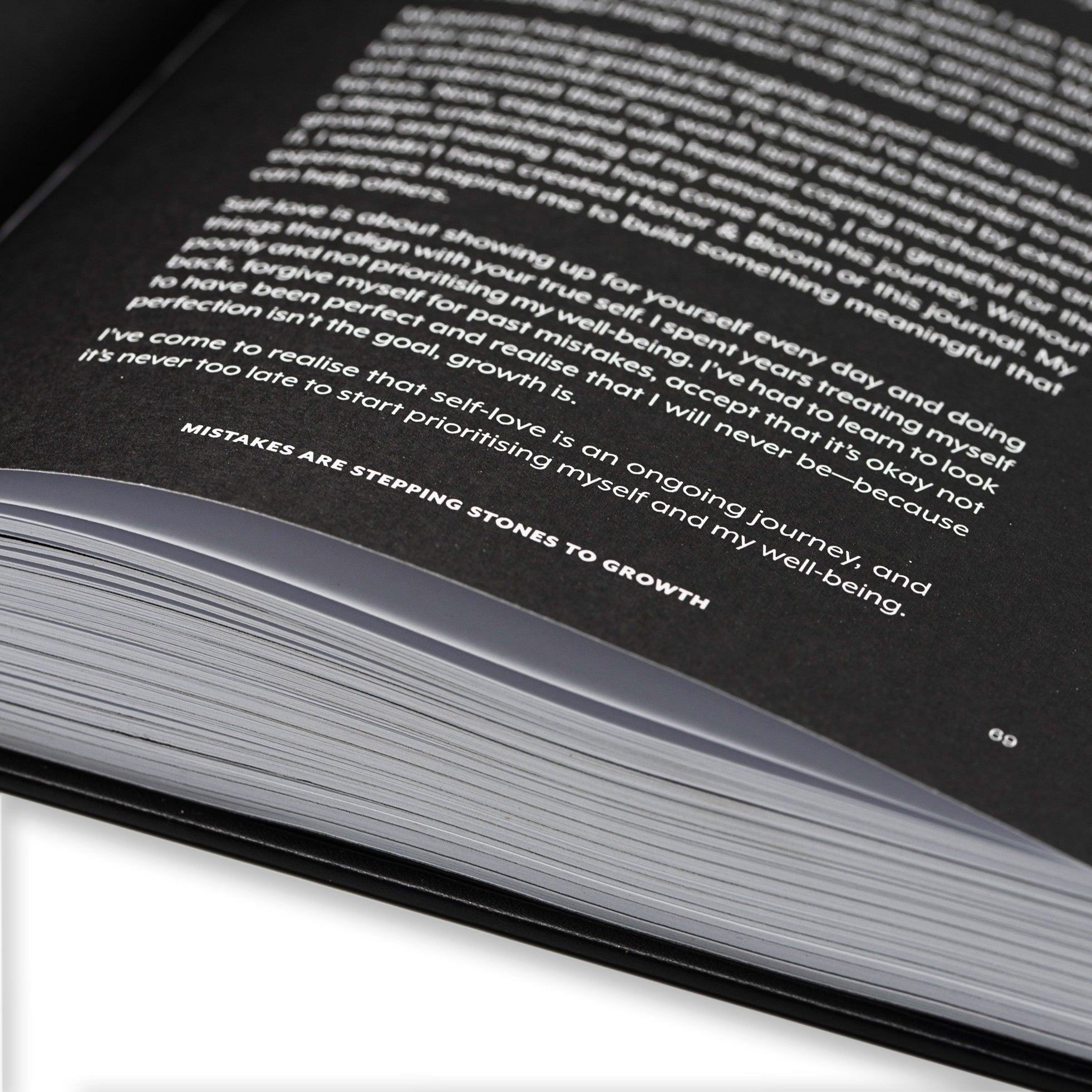 Close-up of guided journal with text on a white background