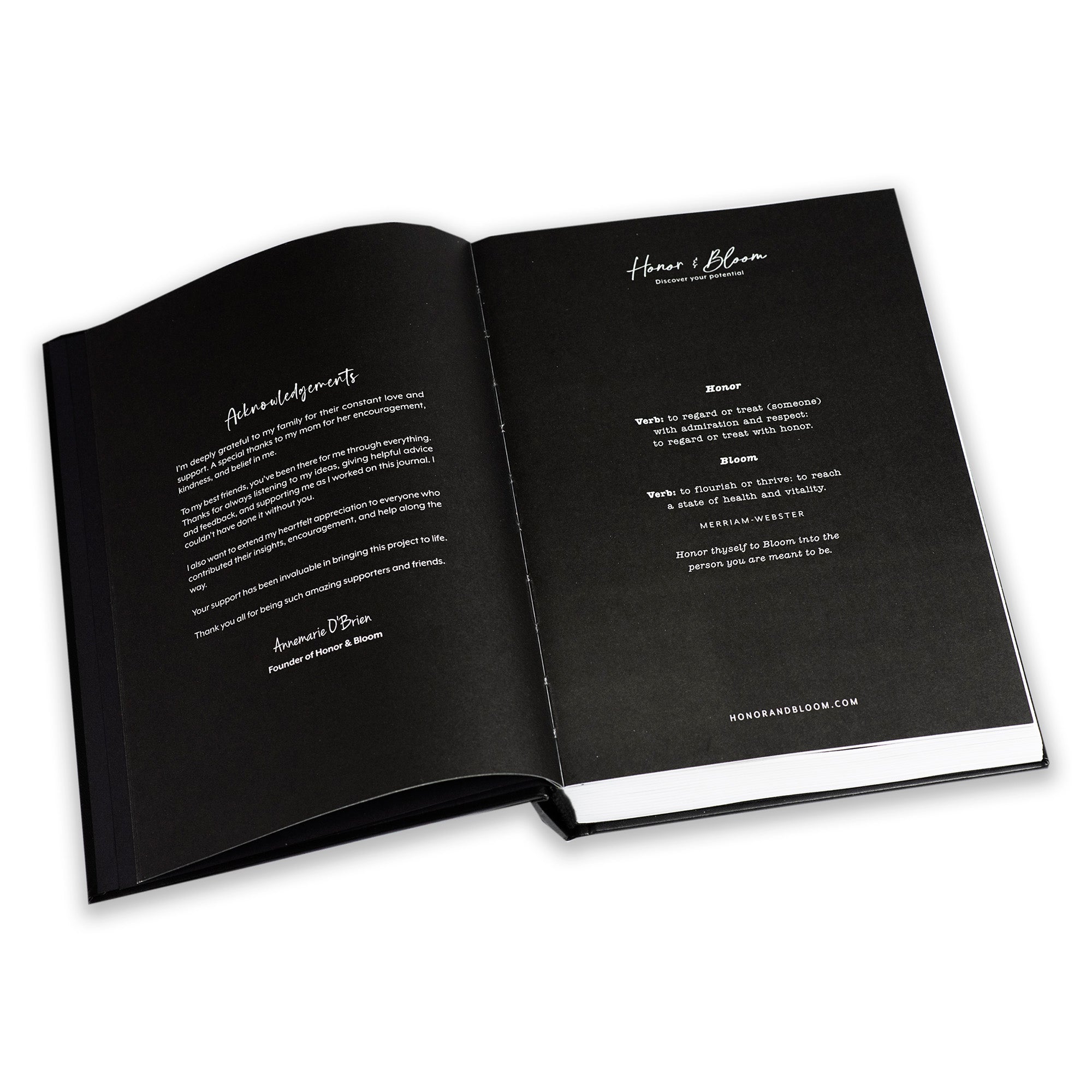 Open guided journal with black pages and white text on a white background