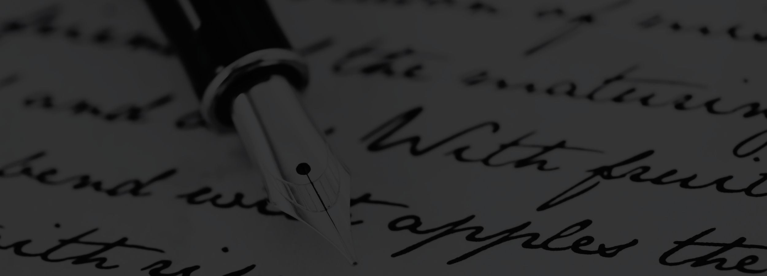 Close-up of a pen on handwritten text