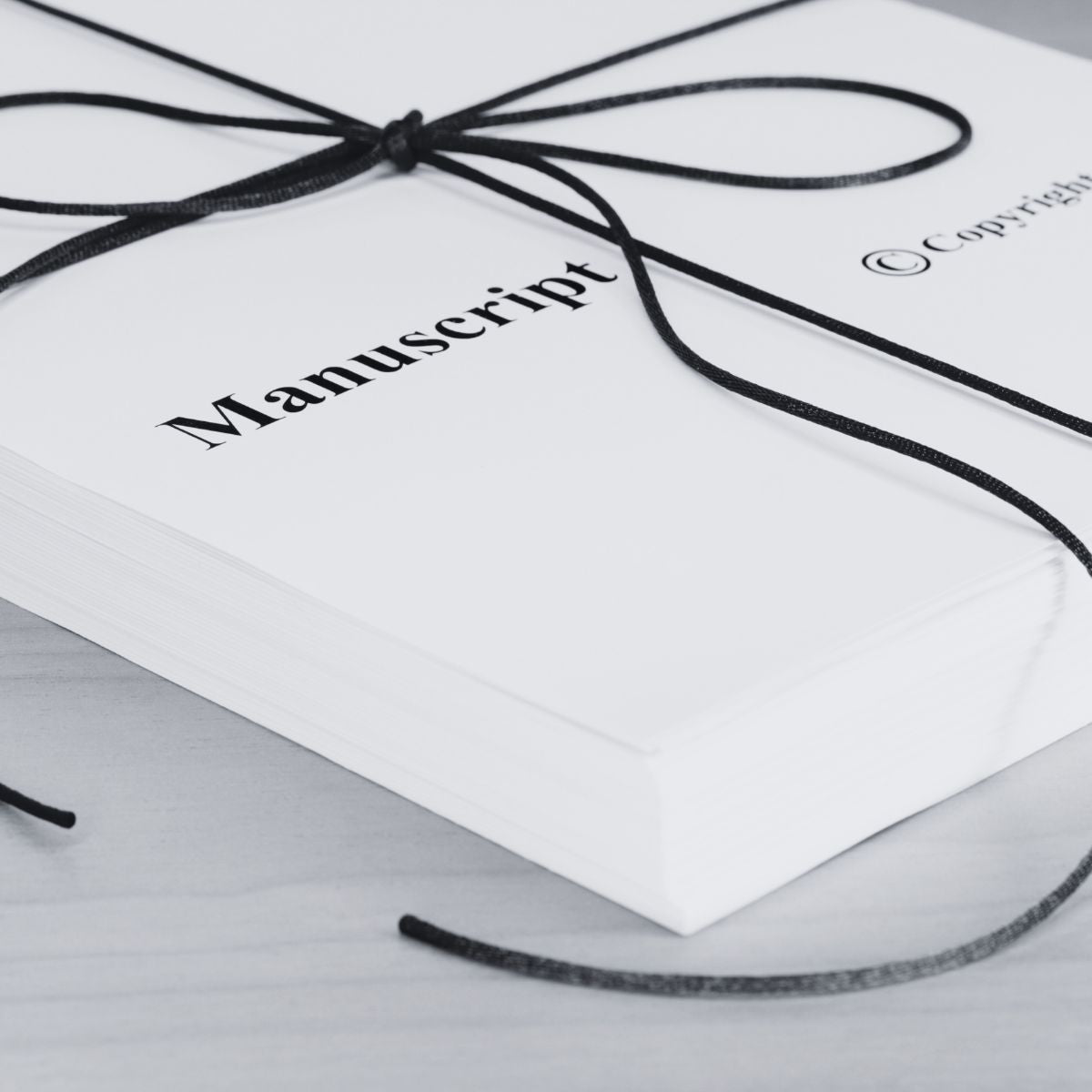 Manuscript branded product with a black cord on a white background