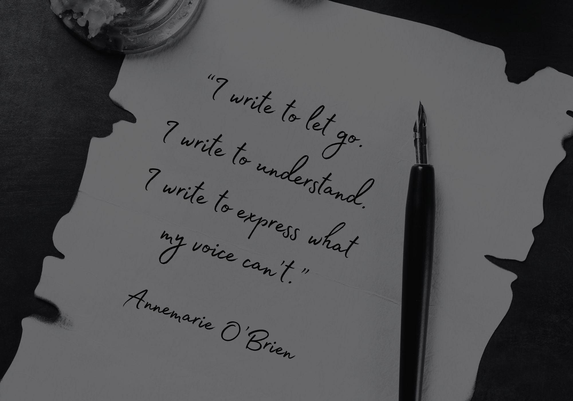 Inkwell, quill pen, and paper with a quote by Annemarie O'Brien on a dark background